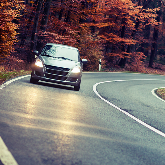 car-2-product Car driving down quiet road in Autumn to promote car insurance by Evalee Insurance Brokers
